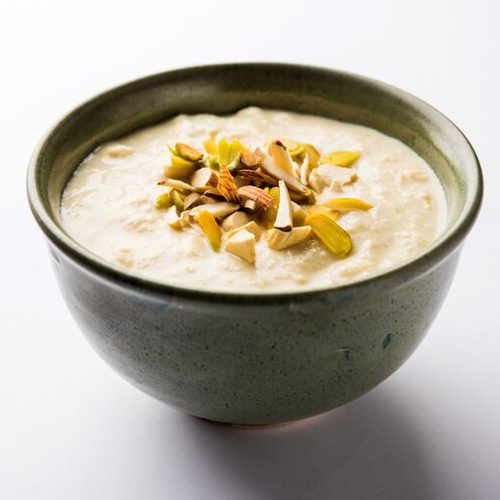 different-lentils-mini-white-spice-bowls-black-stone-table-side-view